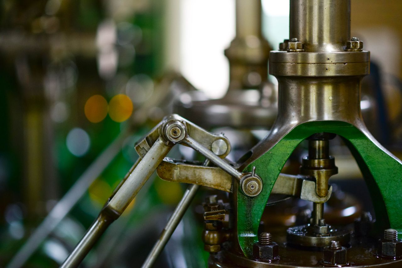 Detailed view of mechanical components in an industrial setting, showcasing metal gears and levers.